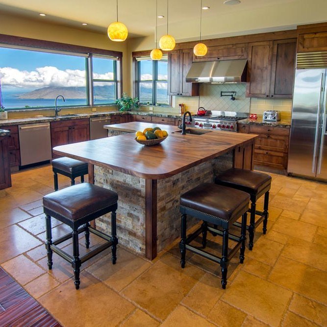 Gourmet kitchen with stainless appliances, a large island, and an ocean-view window